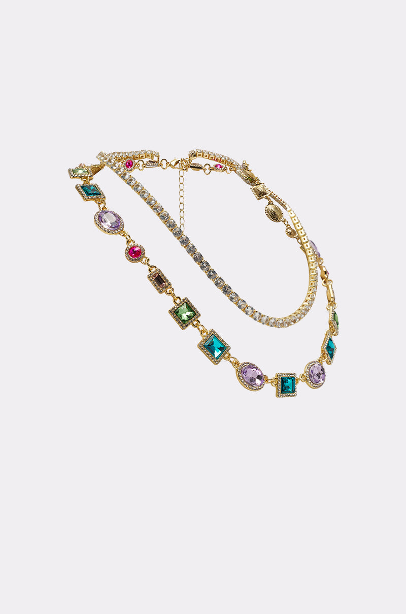 The RAY NECKLACE is a stunning gold statement piece adorned with vibrant multicolored stones. 2