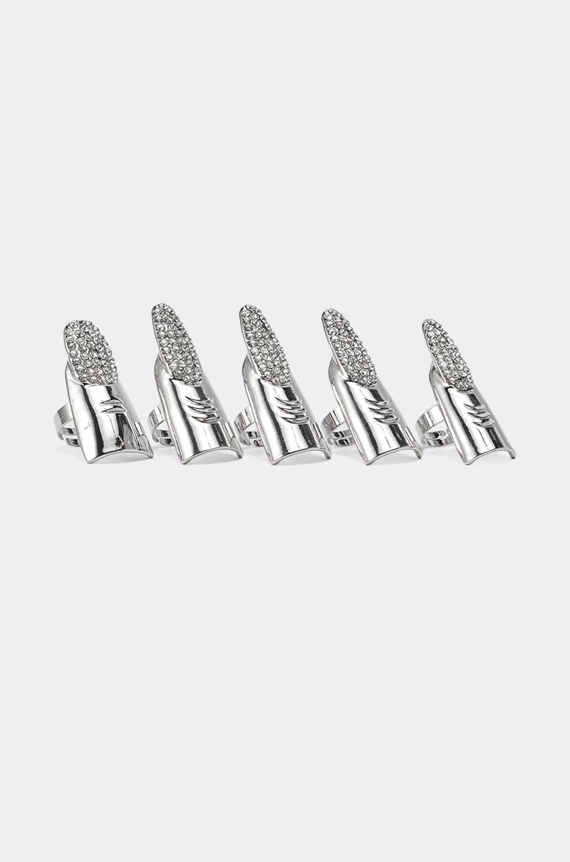 The STELLA RING SET includes five shiny silver finger armor rings, each with a rhinestone pavé nail-like surface, a smooth metal base, and an open band—ideal for making a bold statement. 4
