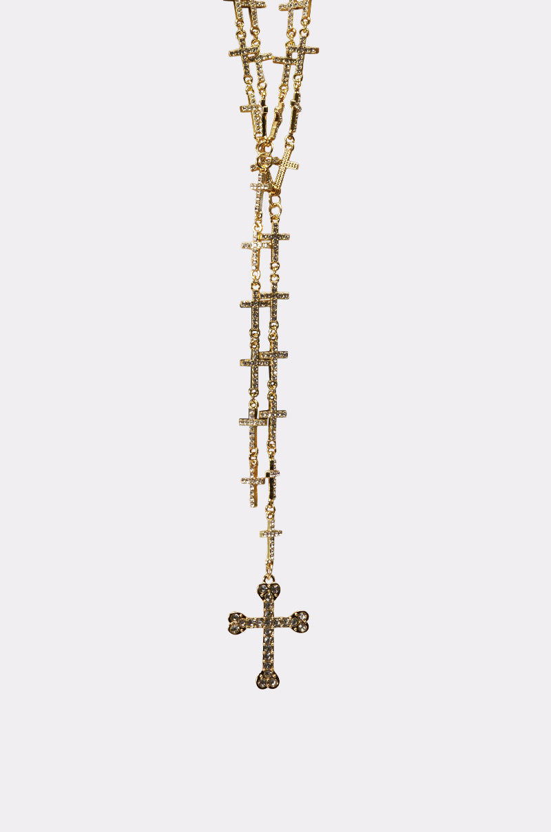 THE ONE NECKLACE: A gold-tone statement necklace with a beaded chain and decorative cross pendant, shown vertically on a plain white background. 4