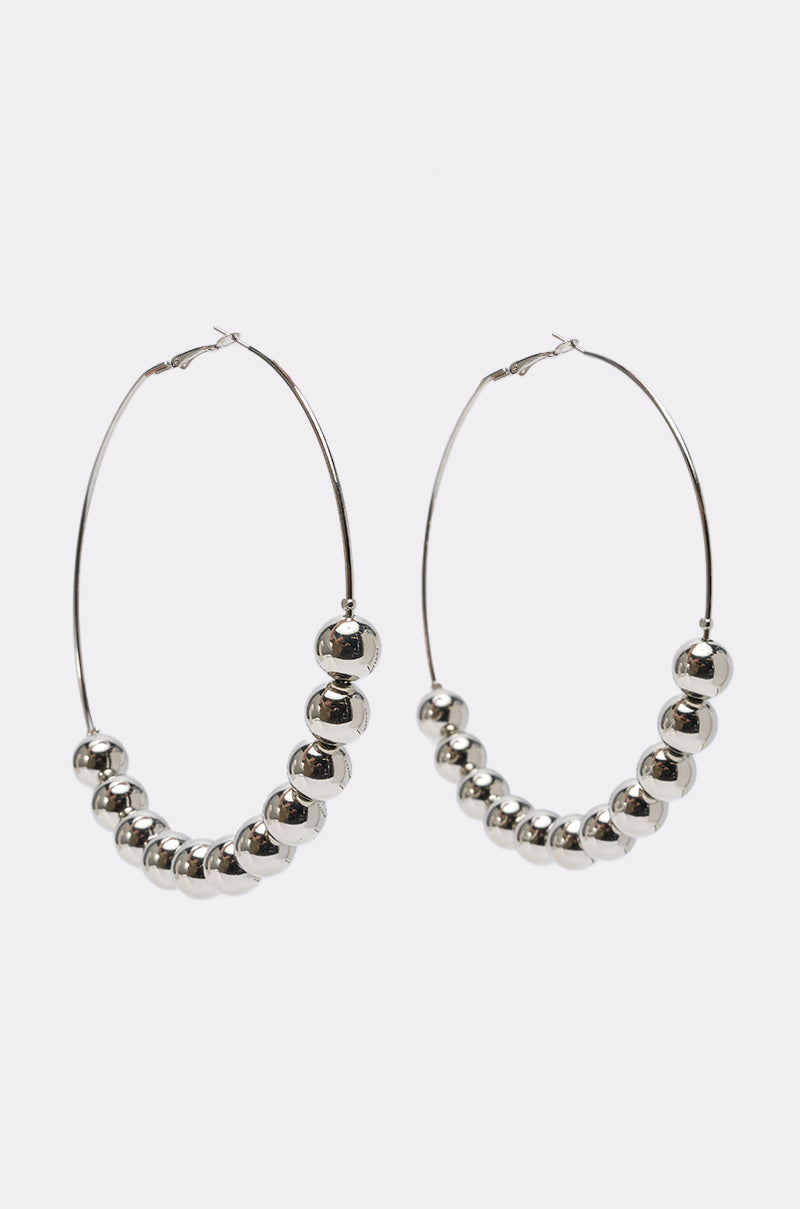 The POP IT JUMBO HOOP EARRING features an oversized design with multiple shiny silver beads along the lower half of each hoop, shown on a white background.