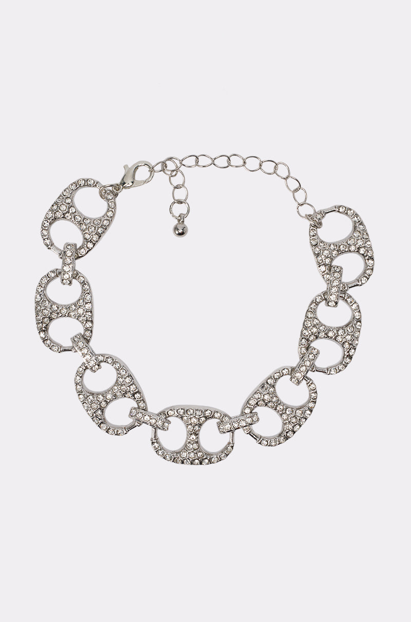 Introducing the POP IT LINK BRACELET: a silver chain bracelet featuring oval links adorned with small clear rhinestones and finished with an adjustable clasp closure—an elegant accessory for festival jewelry, showcased against a plain white background.