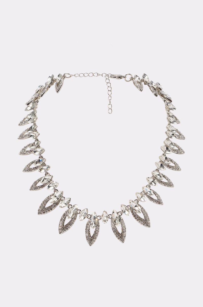 The CALL ME NECKLACE is a silver-tone piece featuring textured leaf-shaped pendants evenly spaced along the chain in a bold, symmetrical design. It includes an adjustable clasp for customizable length.