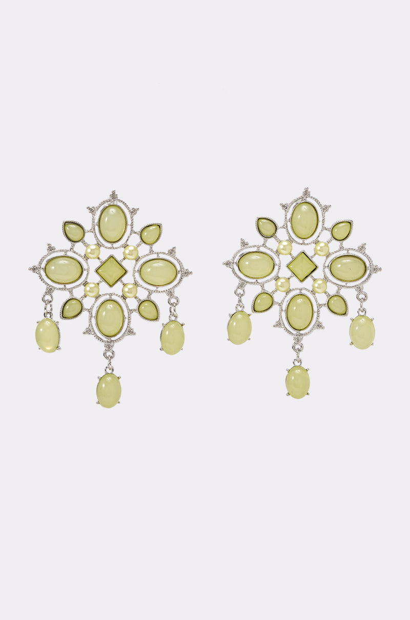 The FESTIVAL VIBES STATEMENT EARRING is a pair of ornate, symmetrical earrings with silver settings, featuring oval and diamond-shaped pale green gemstones and dangling oval gems.