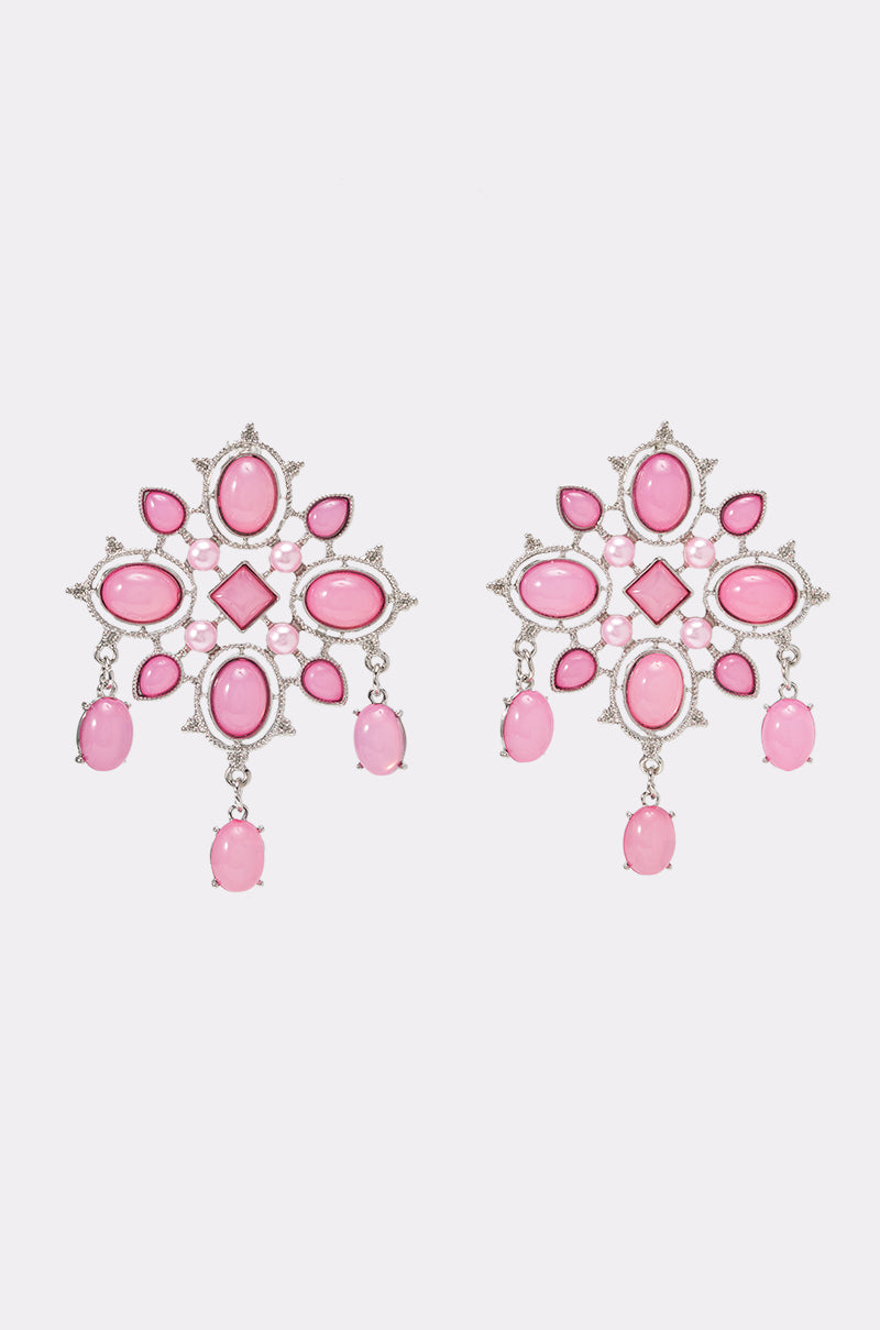 The FESTIVAL VIBES STATEMENT EARRING IN PINK features an ornate design with intricate silver-toned filigree, showcasing various shapes of pink gemstones and three dangling oval stones—perfect statement earrings for adding elegance to your festival outfits.