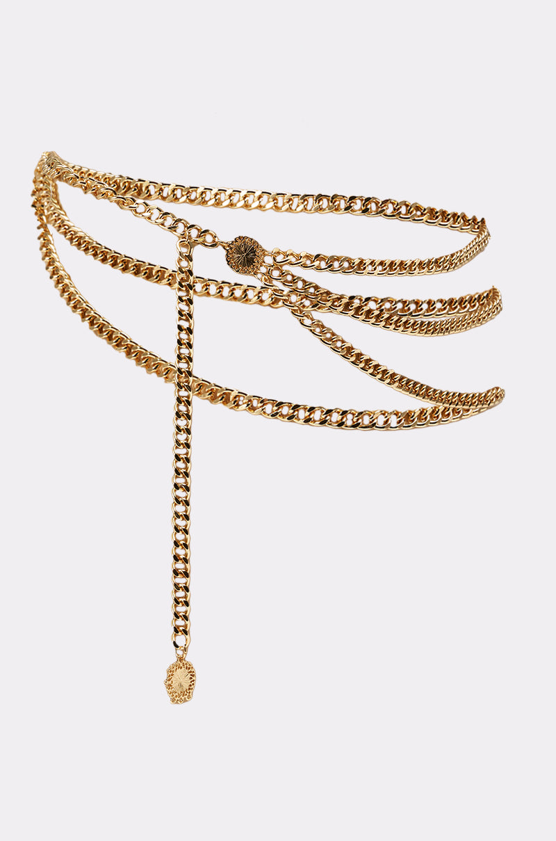 The BUY ME DESIGNER CHAIN BELT is a statement accessory with multiple curved gold layers and a dangling chain accent, beautifully displayed against a plain white background. 2