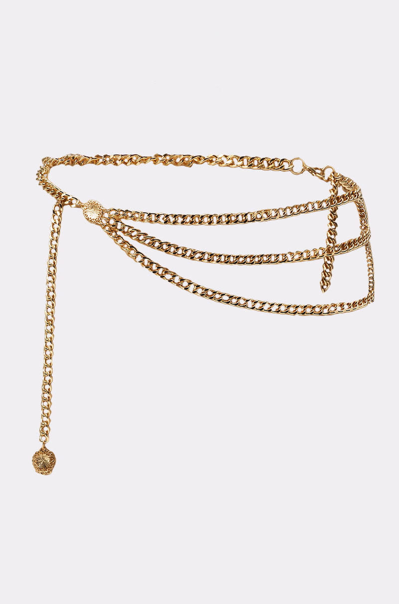 The BUY ME DESIGNER CHAIN BELT showcases a gold-tone layered curb chain design, with multiple chains draping elegantly on one side and a dangling charm, all set against a plain white background. 3