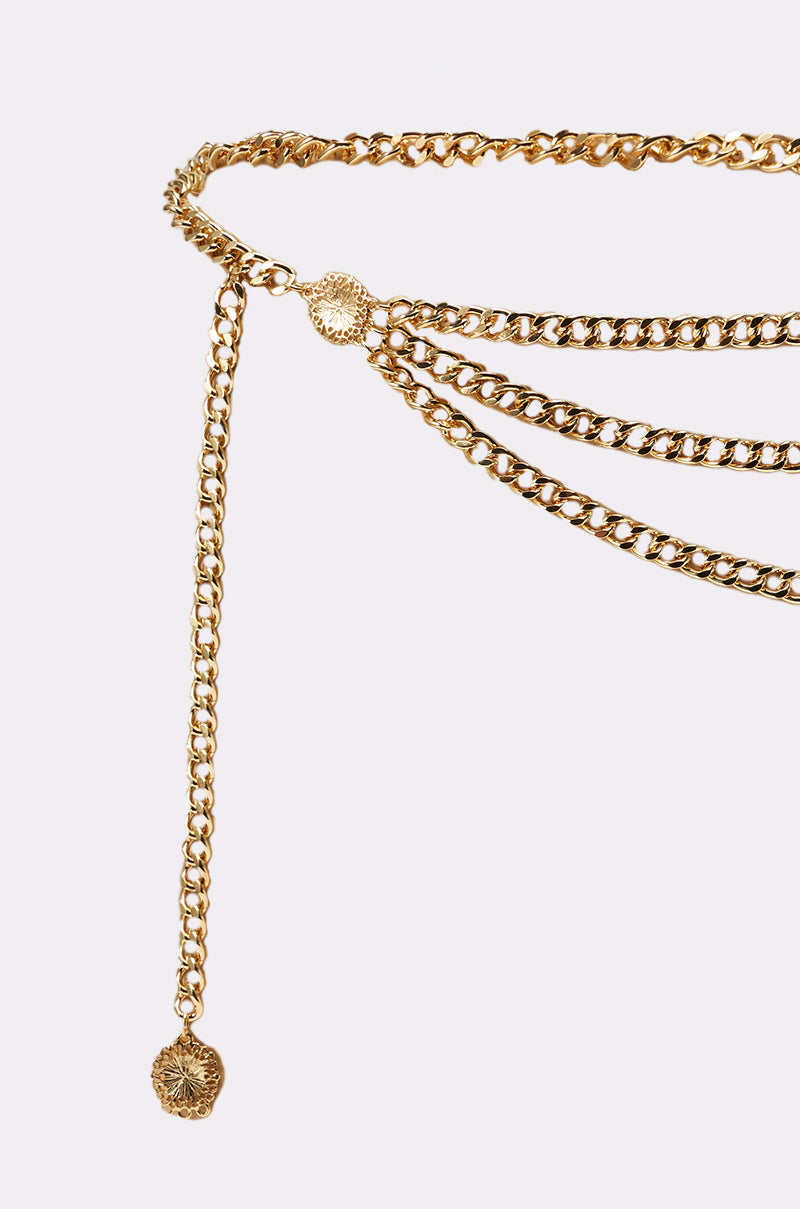 The BUY ME DESIGNER CHAIN BELT features a gold-tone layered curb chain with round textured medallion charms at the ends, shown against a light background. 4