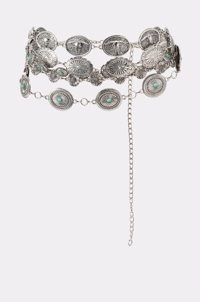 The WILD WEST LAYERED CHAIN BELT is a silver Southwestern accessory with oval and round engraved medallions, turquoise accents, small chain links, and a dangling adjustable closure. 2