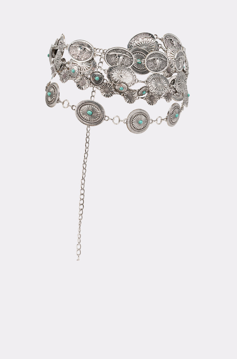 The WILD WEST LAYERED CHAIN BELT features silver-toned oval conchos with turquoise accents, inspired by elegant concho belts, and includes a dangling chain for adjustable fastening. 3