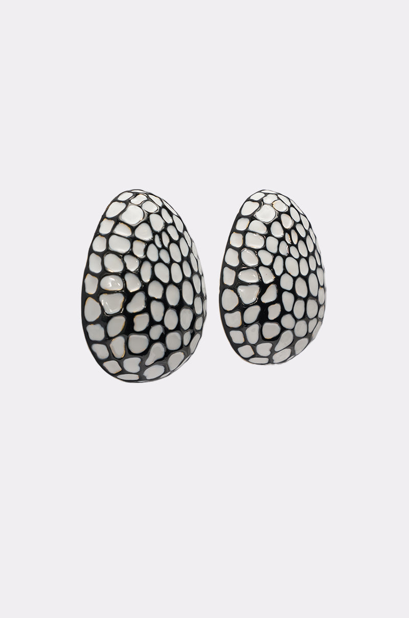 The CANT LOSE EARRING is a pair of mosaic-inspired, black and white oval earrings with an irregular dot pattern, shown on a plain light gray background. 2