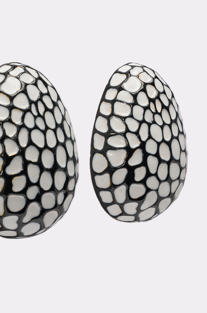 Close-up of the CANT LOSE EARRING, featuring mosaic-inspired oval earrings with a black and white pattern reminiscent of animal scales or pebbles, displayed against a plain white background. 3