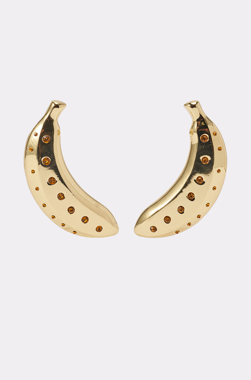 The GOING BANANAS EARRING features gold earrings shaped like bananas, each adorned with small circular brown gemstones, shown on a plain white background. 0