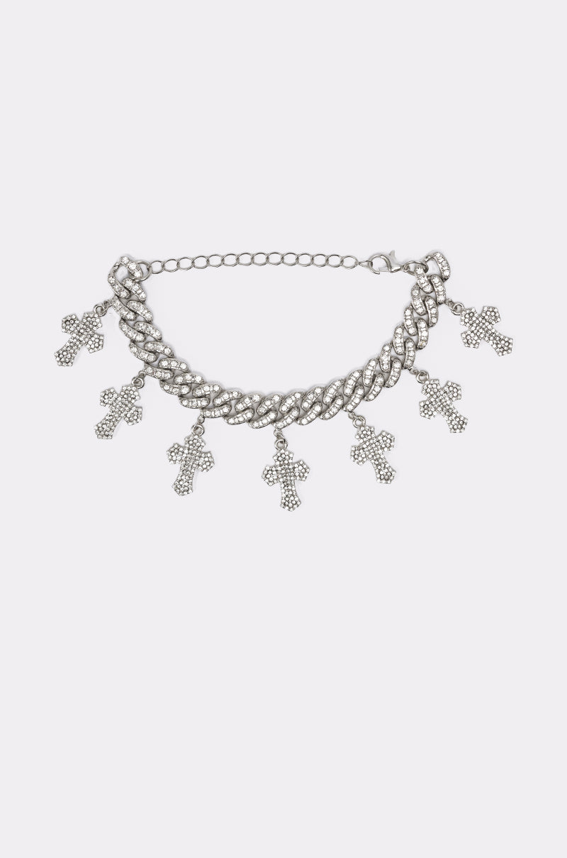 The ICED OUT CHARM BRACELET is a chunky curb-link silver bracelet with five rhinestone-studded cross charms, elegantly displayed on a plain white background. 2