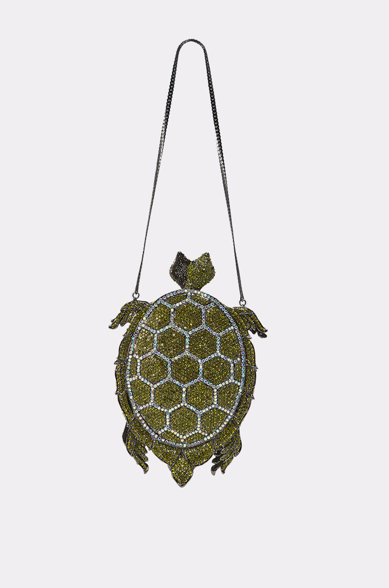 The BY THE SEA BLING PURSE is a turtle-shaped evening bag adorned with green and gold crystals, featuring a hexagonal shell pattern and thin metallic strap—a perfect statement rhinestone clutch. 2