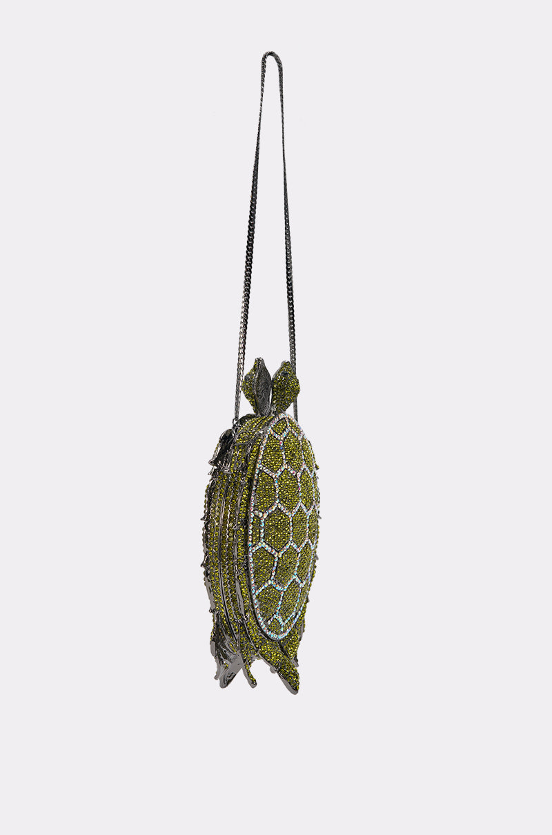 The BY THE SEA BLING PURSE is a turtle-shaped clutch with a long black strap and a shell design made of green and yellow rhinestones, creating a dazzling statement evening bag against a plain white background. 4