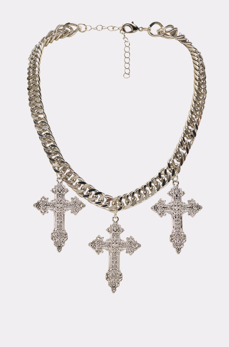 The TRIPLE CROSS CHAIN NECKLACE showcases a bold, chunky silver chain adorned with three ornate, jeweled cross pendants spaced evenly along its length. This striking streetwear statement piece adds a touch of edgy elegance to any outfit and is photographed against a plain white background.