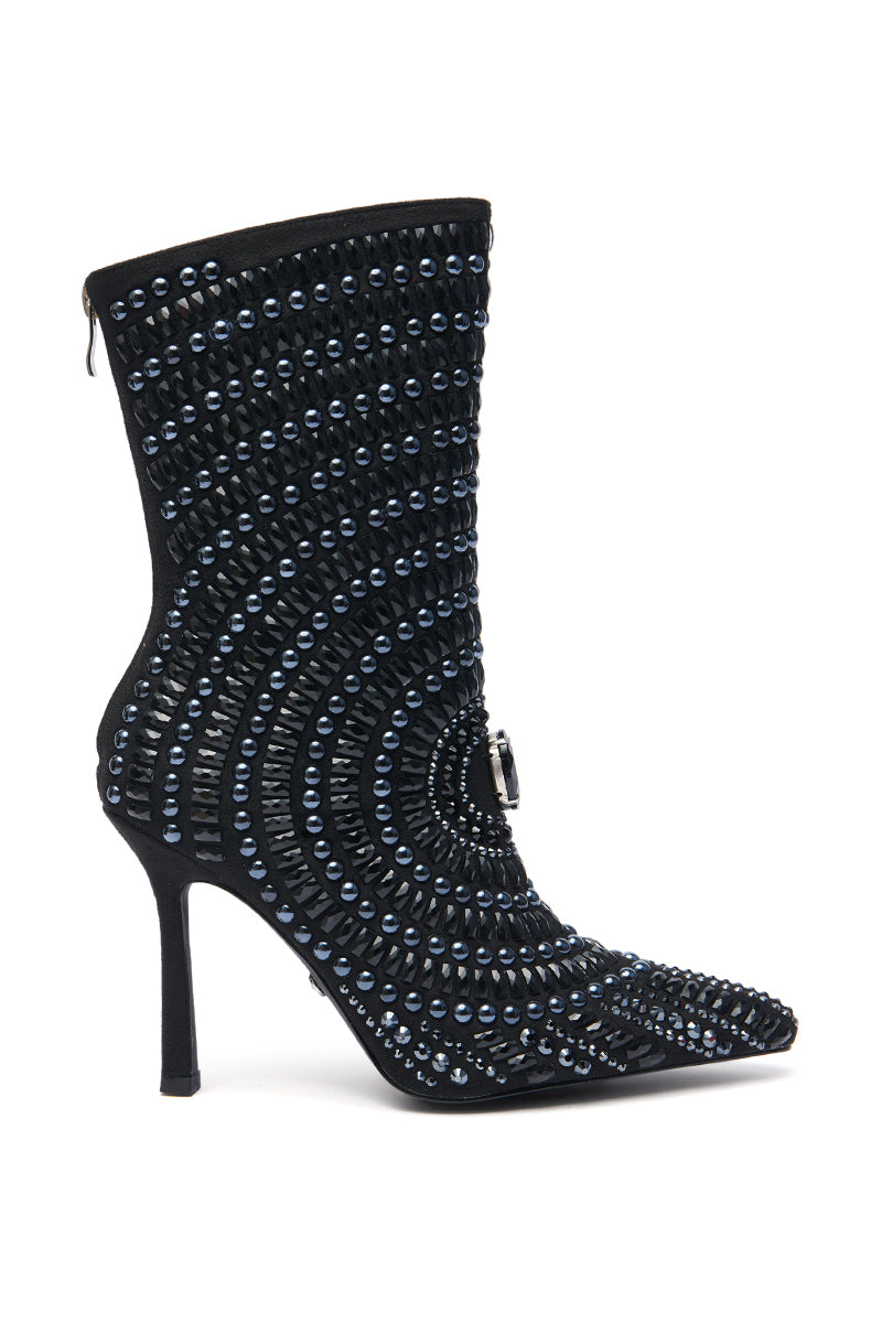 The AZALEA WANG HILLEL PEWTER RHINESTONE BOOTIE is a stiletto bootie with concentric rows of blue and black studs, a pointed toe, faux suede finish, and a circular buckle detail near the ankle.