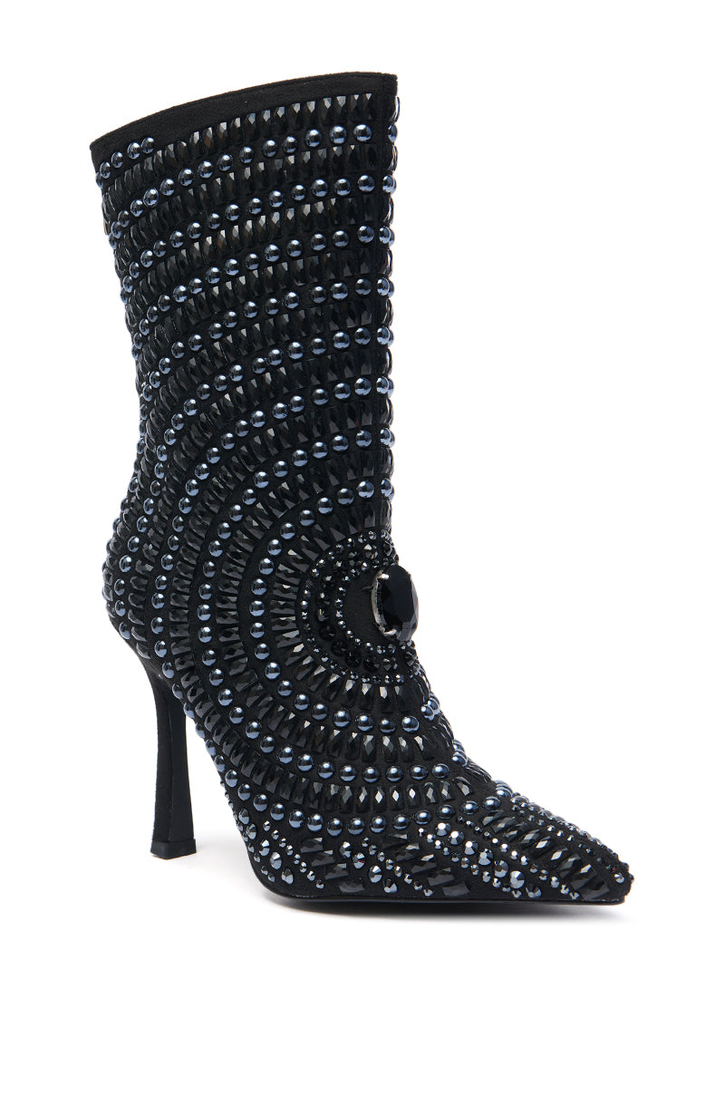 The AZALEA WANG HILLEL PEWTER RHINESTONE BOOTIE is a black stiletto faux suede boot with a pointed toe, concentric rows of sparkling studs, and a bold gemstone accent for standout style.