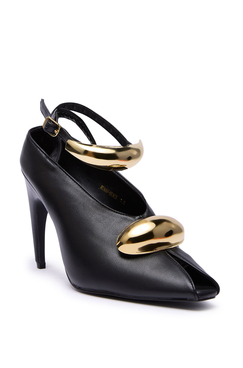 The AZALEA WANG HIMAH BLACK OPEN TOE PUMP is a faux leather stiletto featuring an open toe and two striking gold accents across the ankle and front, all showcased against a white background.