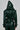 The MONTE CARLO HOODED MOTO in evergreen shows a back view of a person with the faux leather hood up, matching pants, buckled cuffs, and a belted waist against a gray background.