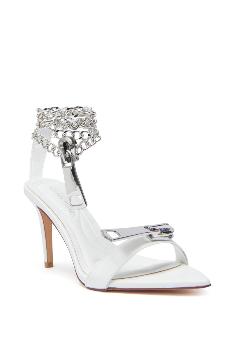 The AZALEA WANG HORUS WHITE ZIPPER EMBELLISHMENT SANDAL features a stiletto heel, square toe, faux leather, plus silver chain and buckle details on the ankle and front strap.