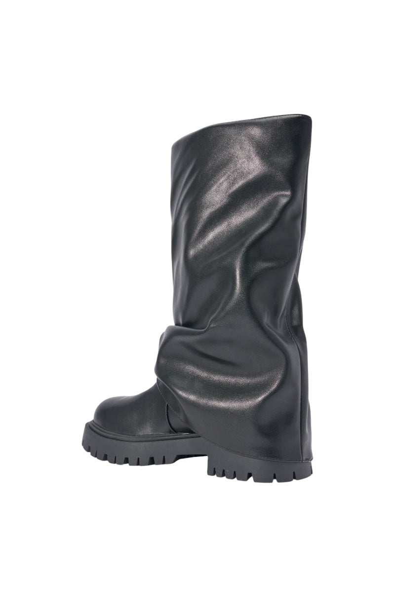 The AZALEA WANG HOYT BLACK FLAT RUCHED BOOTIE is shown solo on a white background, featuring a knee-high slouchy design, wrinkled faux leather texture, chunky platform lug sole, and relaxed silhouette for standout style. 5