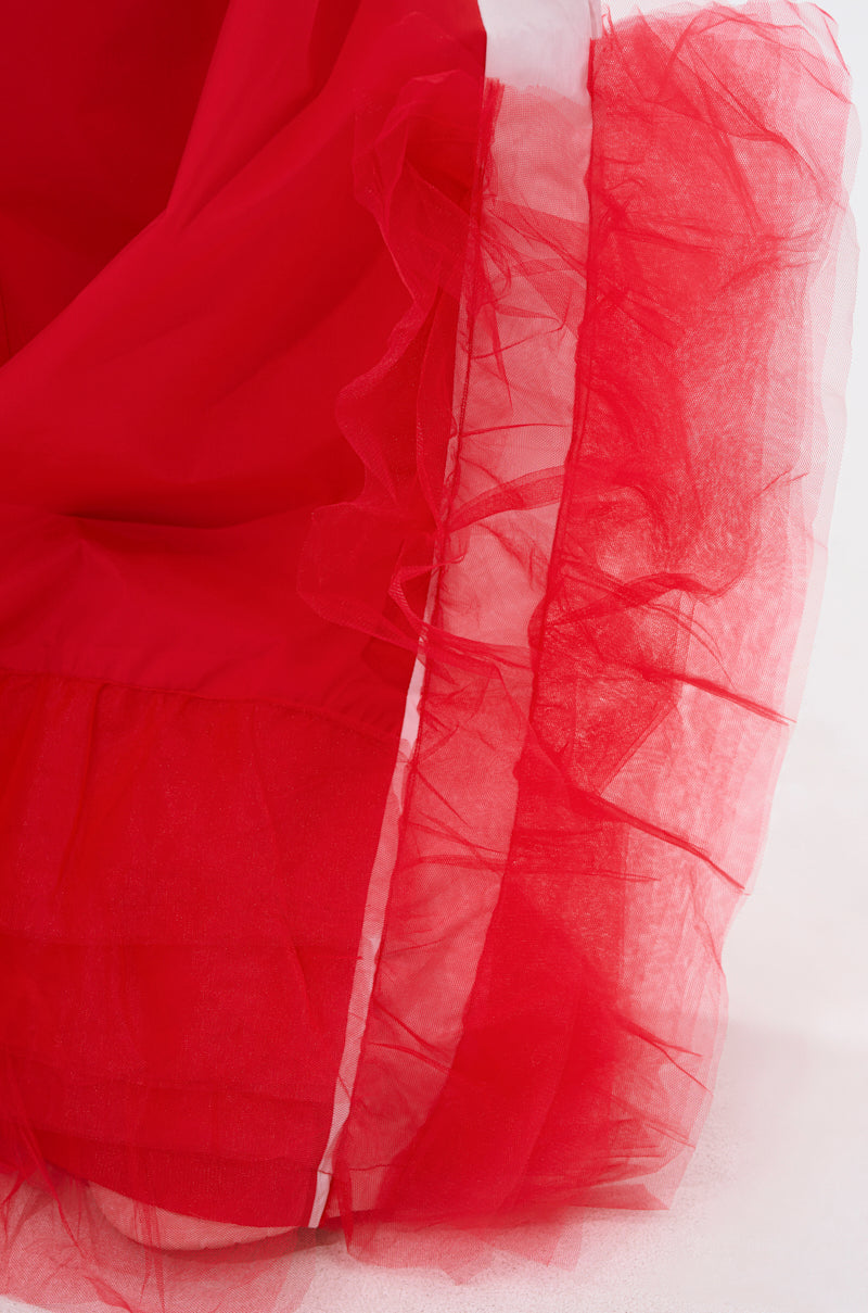 Close-up of FEELING LIKE A BOSS TRACK PANT WITH TULLE TRIM IN RED, showing layers of vibrant red tulle trim arranged in soft folds and ruffles for a sheer, textured look against a light background. 6