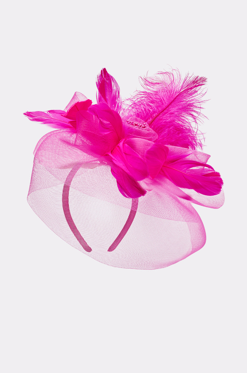The DERBY DAY PINK FASCINATOR features bright pink mesh netting, large fabric flowers, and fluffy feathers on a matching headband—an elegant wedding accessory shown against a plain white background. 3