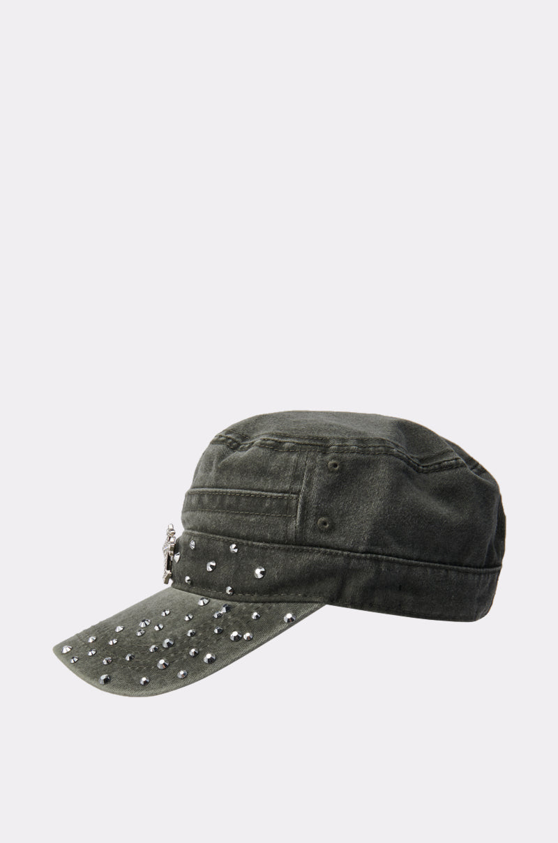 The GET WITH IT HAT is a dark green military-style cap made from denim-like fabric, featuring silver studs on the brim and a small metal emblem on the side, shown against a plain light background. 3