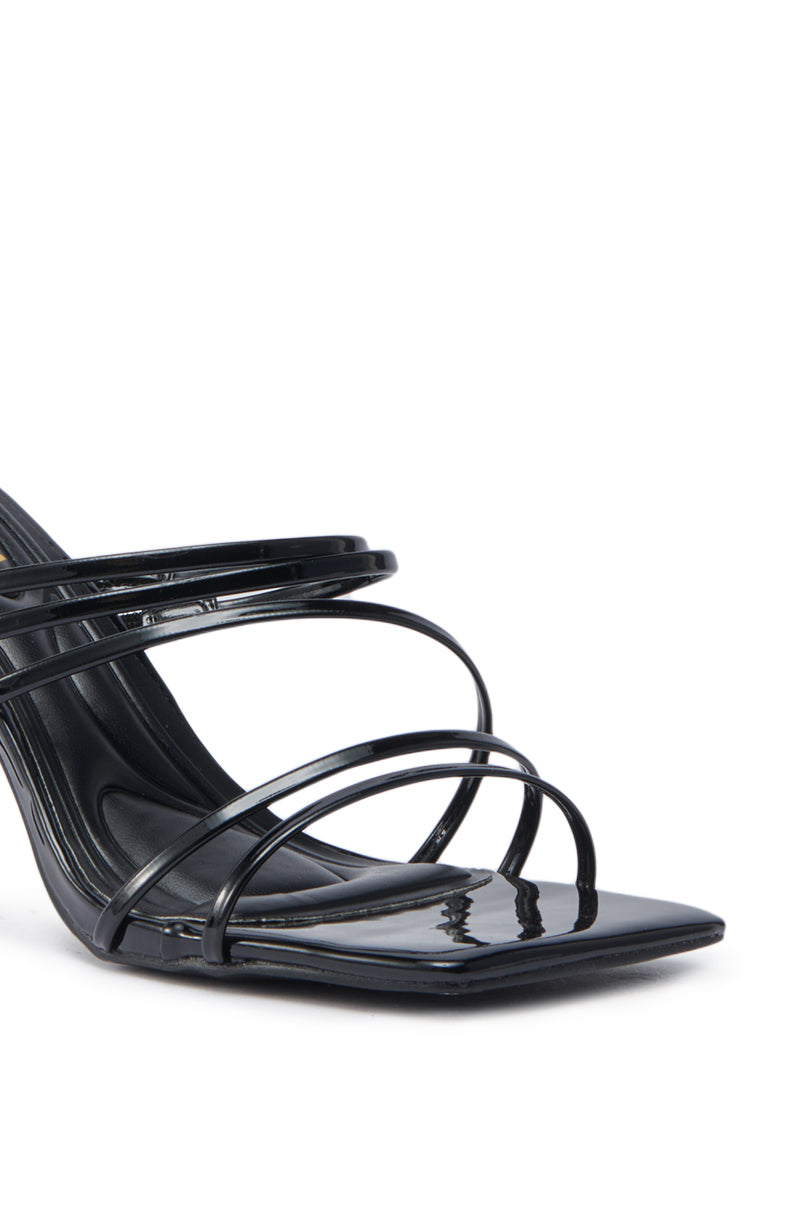 Close-up of the AZALEA WANG HUGHIE BLACK SANDAL—a black stiletto heel with a square toe and multiple thin, glossy faux patent leather straps crossing the front.