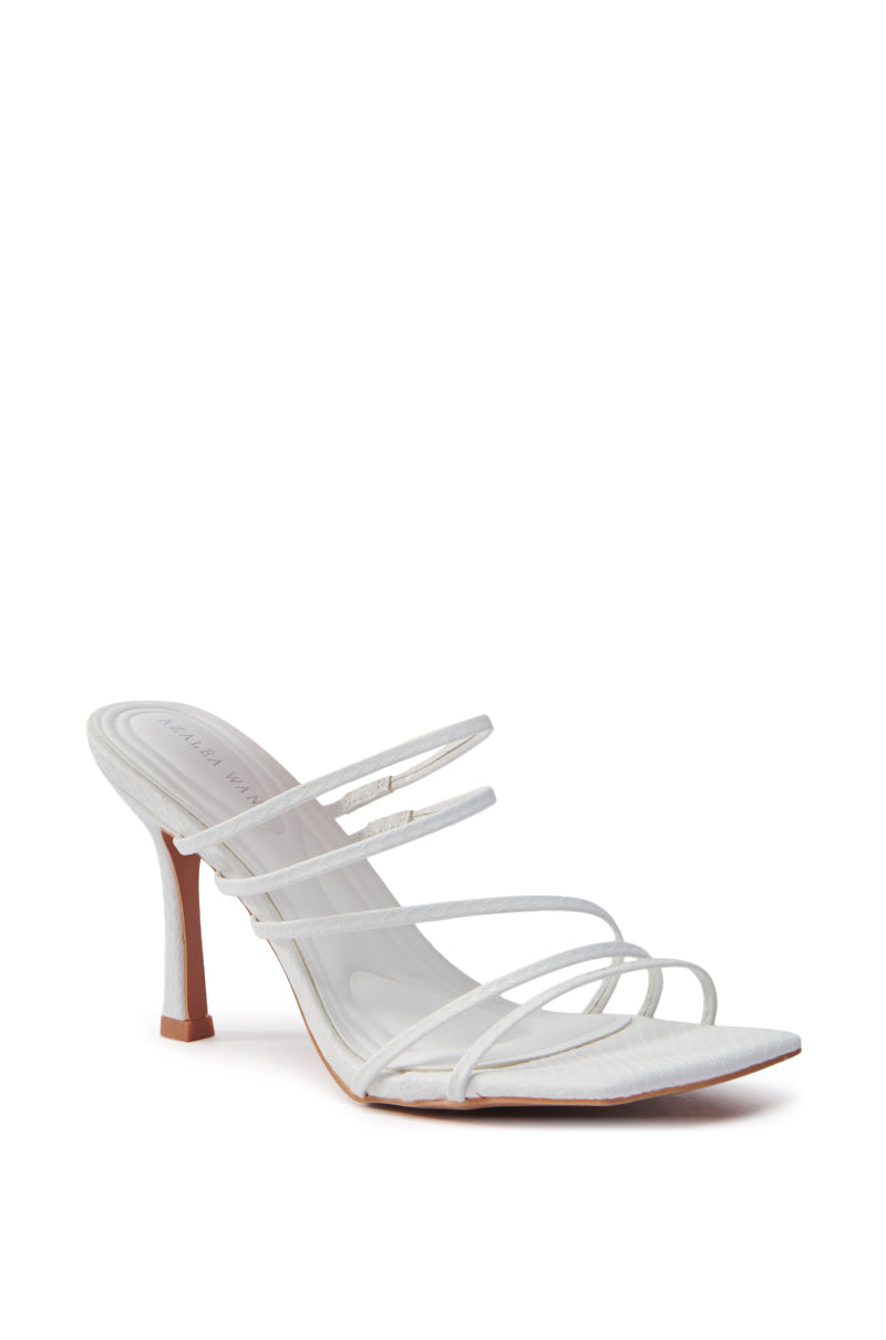 The AZALEA WANG HUGHIE WHITE SNAKE SANDAL is a single white vegan leather high-heeled shoe with multiple slim straps, a pointed toe design, and a slender stiletto heel. It has a sleek, minimalist style displayed on a plain white background.