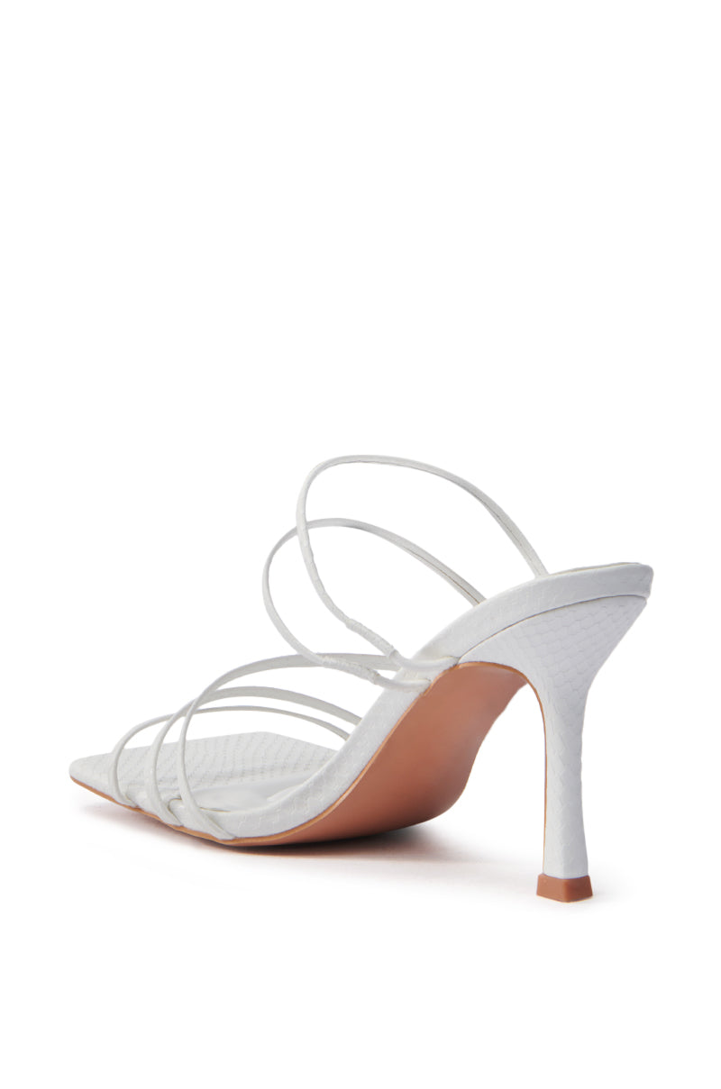 The AZALEA WANG HUGHIE WHITE SNAKE SANDAL is a stylish vegan leather high-heeled sandal with a slender stiletto and textured surface, featuring an elegant design with multiple thin straps and a brown sole.