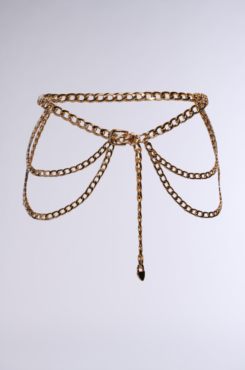 Introducing the WESTERN LAYERED CHAIN BELT - a sophisticated accessory featuring draped chain links arranged in a layered design around the waist. This metallic chain belt boasts a central clasp and an additional chain hanging from the center, offering a stylish and elegant touch to any outfit. The product is showcased against a plain white background. 2