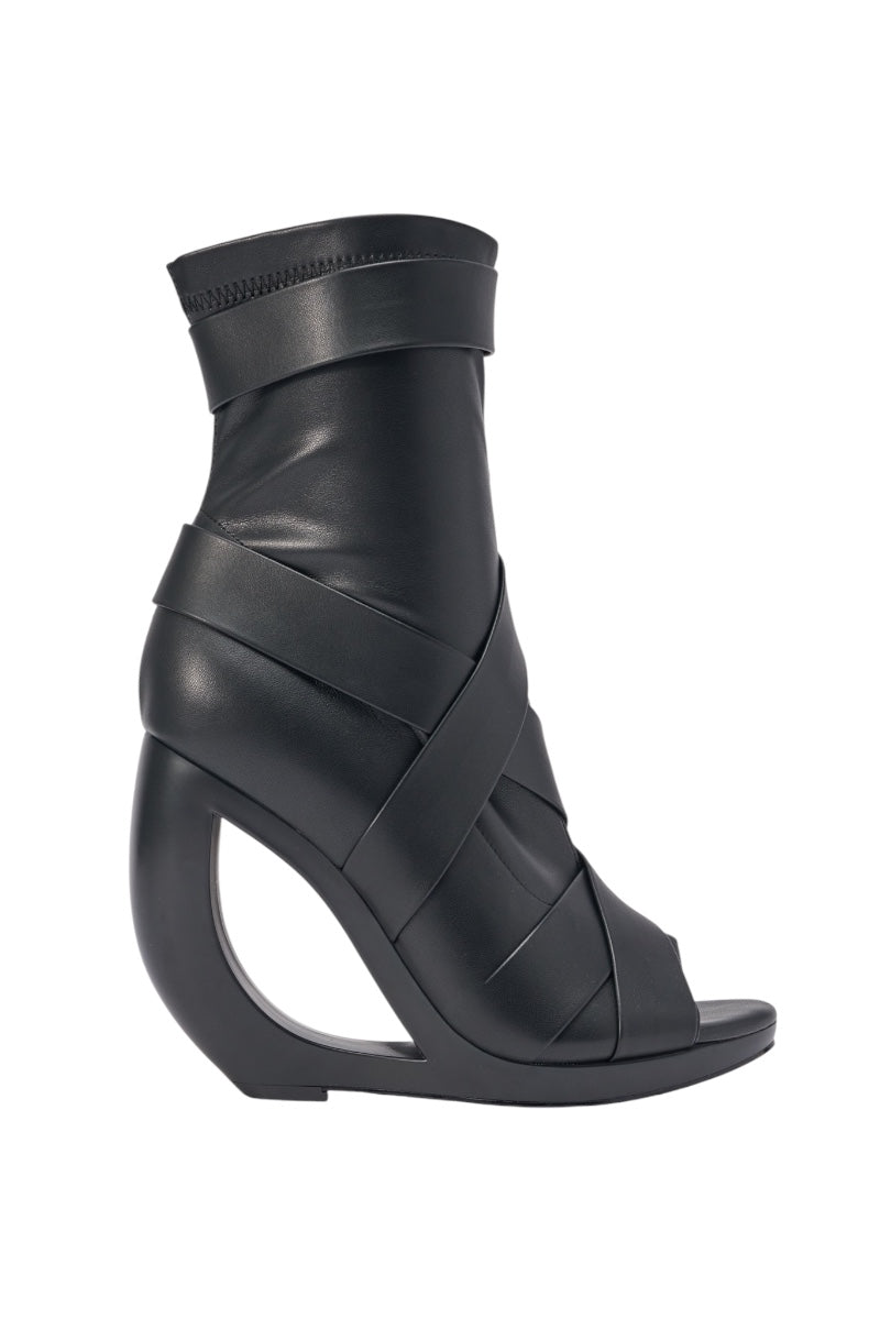 The AZALEA WANG IGNITE Black Wedge Open Toe Bootie features belting detail, a striking cutout wedge heel, and overlapping straps—ideal as a statement shoe for your next night out. 2