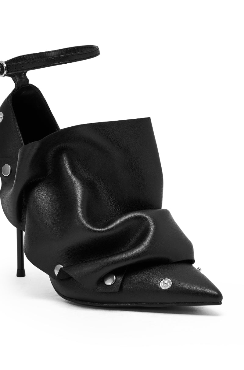 The AZALEA WANG IMOGALE BLACK SILVER HARDWARE STILETTO PUMP is a black pointed-toe stiletto featuring draped, folded leather, silver button accents, and an ankle strap.