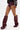 A person wears burgundy high-waisted leather shorts with AZALEA WANG IMOGINE BURGUNDY STILETTO SNAP BOOTS featuring metal studs, paired with a black and white jacket, all set against a plain white background.