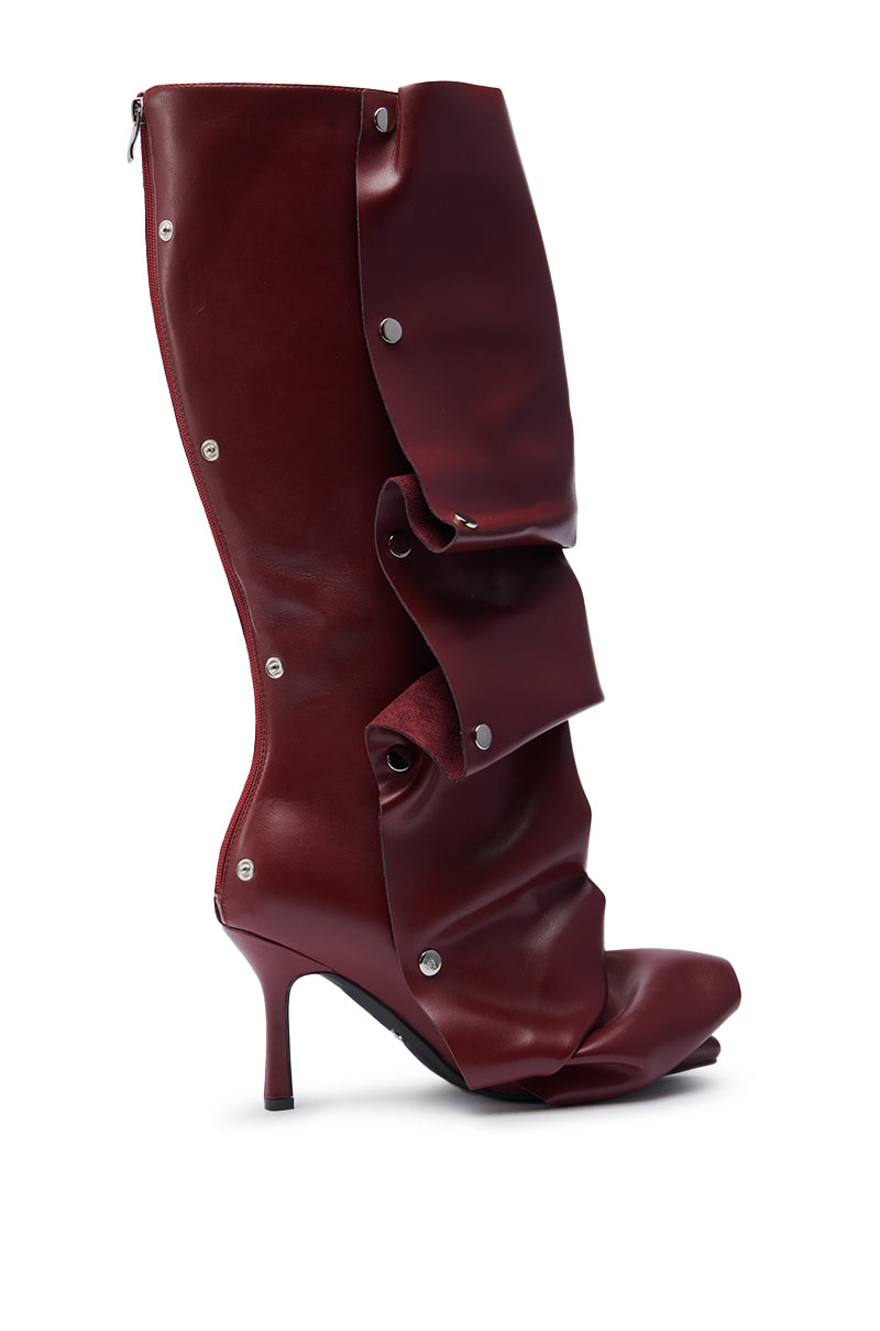 The AZALEA WANG IMOGINE BURGUNDY STILETTO SNAP BOOT features a high heel, pointed toe, dark faux leather with a folded, layered design, sculptural wrinkled look, and silver-tone snap button closure.