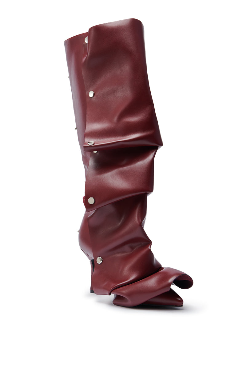 The AZALEA WANG IMOGINE BURGUNDY STILETTO SNAP BOOT is a supple leather boot with a dramatically slouched, wrinkled design, pointed toe, and silver snap buttons along the side.