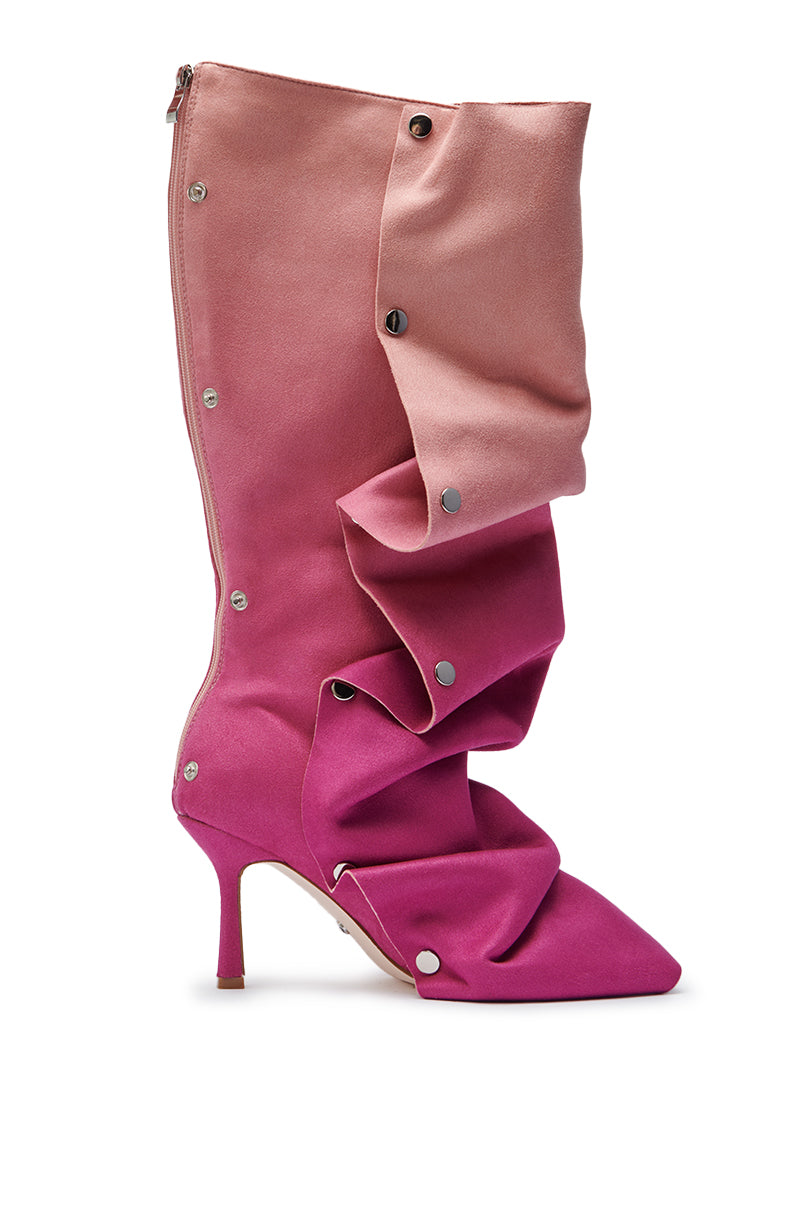 The AZALEA WANG IMOGINE PINK MULTI FAUX SUEDE BOOT is a high-heeled, pointed-toe stiletto featuring a pink-to-fuchsia gradient, dramatic ruffles, and silver snap buttons—ideal for fans of bold pink boots.