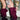A person in a floral embroidered jacket and denim shorts adjusts AZALEA WANG IMOGINE PURPLE OMBRE FOLDED DETAIL STILETTO BOOTS while standing indoors on a textured floor in front of glass blocks.