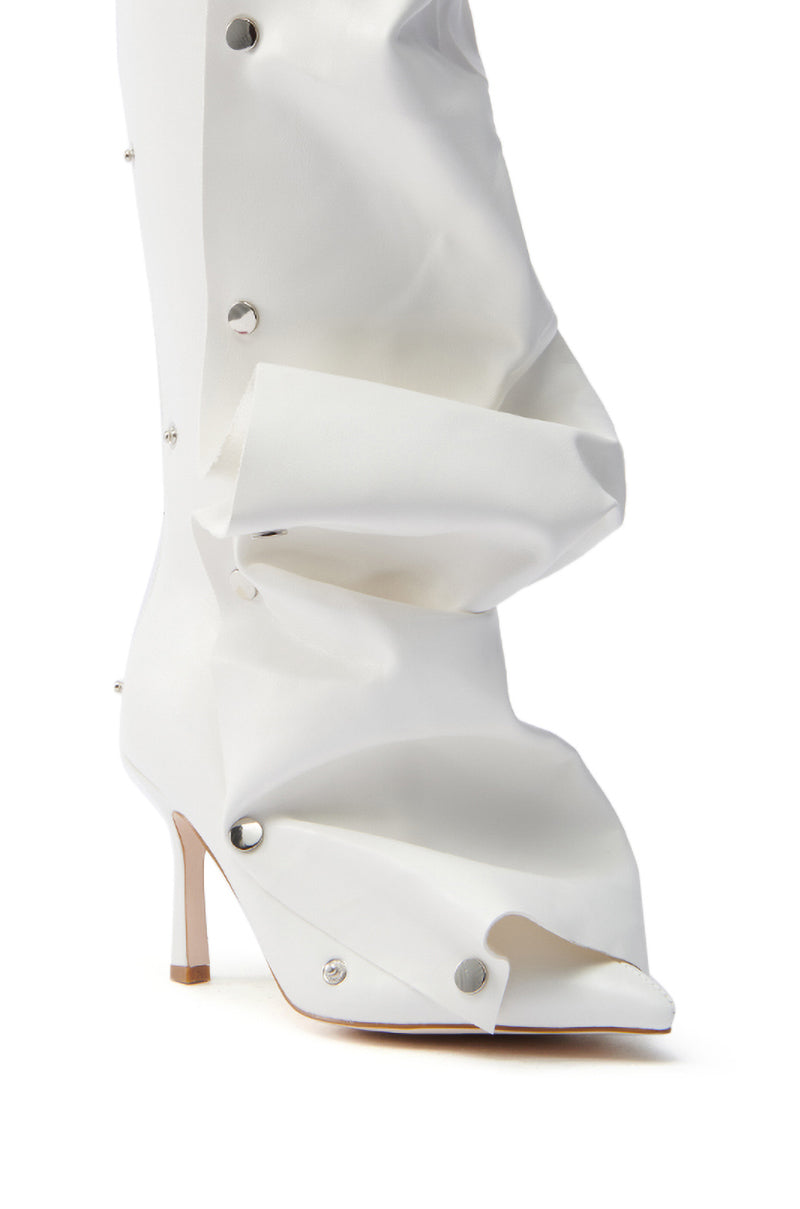 The AZALEA WANG IMOGINE WHITE BOOT is a knee-high boot with a distinctive gathered-ruched design, metal snap buttons, and a pointed toe on a sleek stiletto heel.