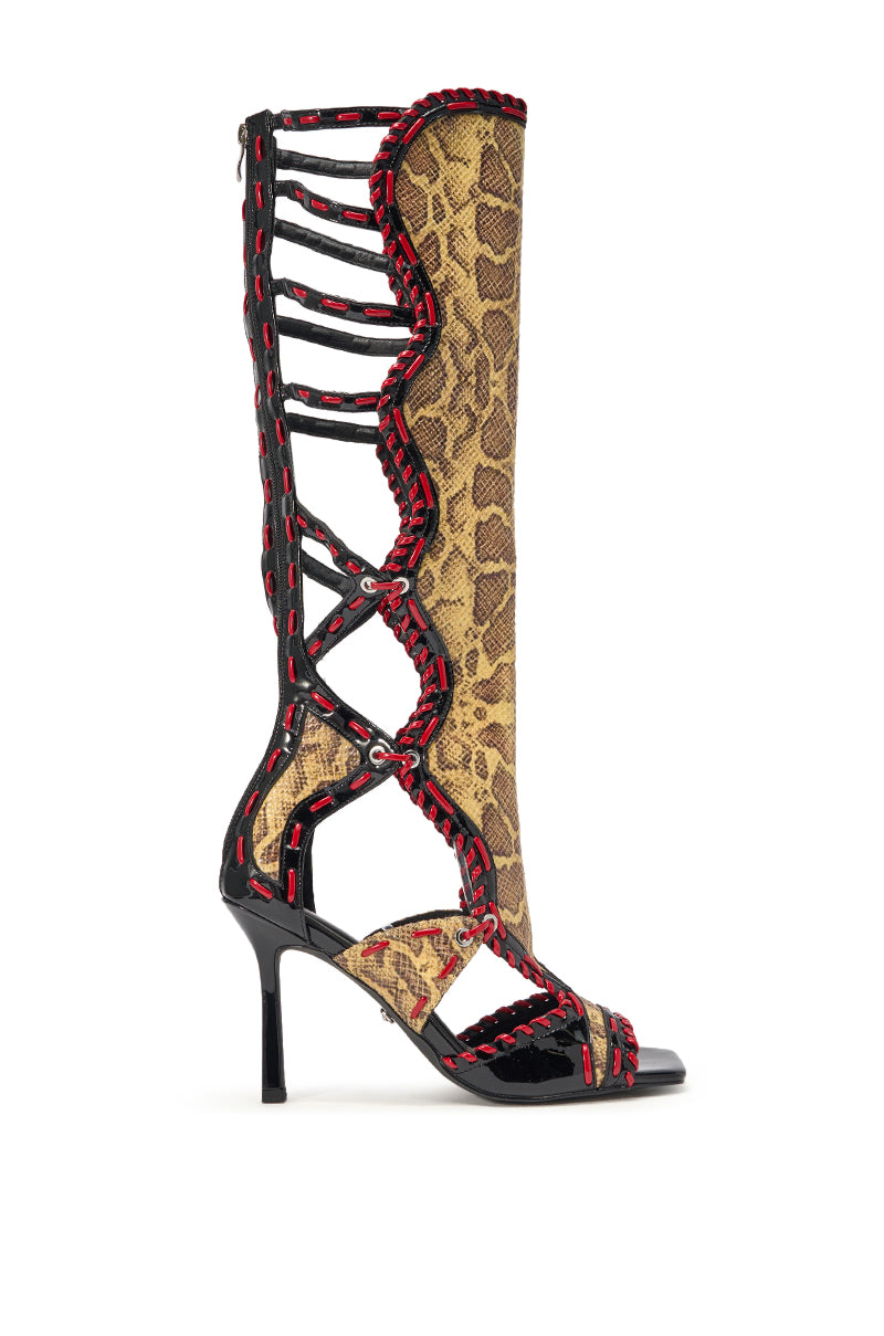 The AZALEA WANG INDRANI HIGH SHAFT YELLOW SNAKE PRINT GLADIATOR SANDAL features bold yellow snakeskin, black straps, red stitched accents, an open toe design, high stiletto heel, and gladiator-inspired faux patent leather details. 4