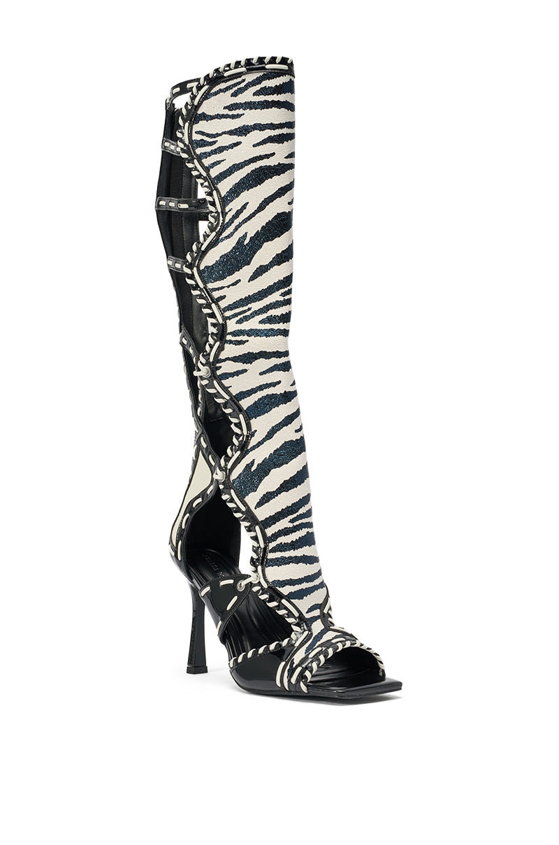 The AZALEA WANG INDRANI HIGH SHAFT BLACK AND WHITE ZEBRA PRINT GLADIATOR SANDAL features high heels, open toes, wavy trim, strappy cutouts, studs, and luxe faux leather for a bold gladiator-inspired look. 4
