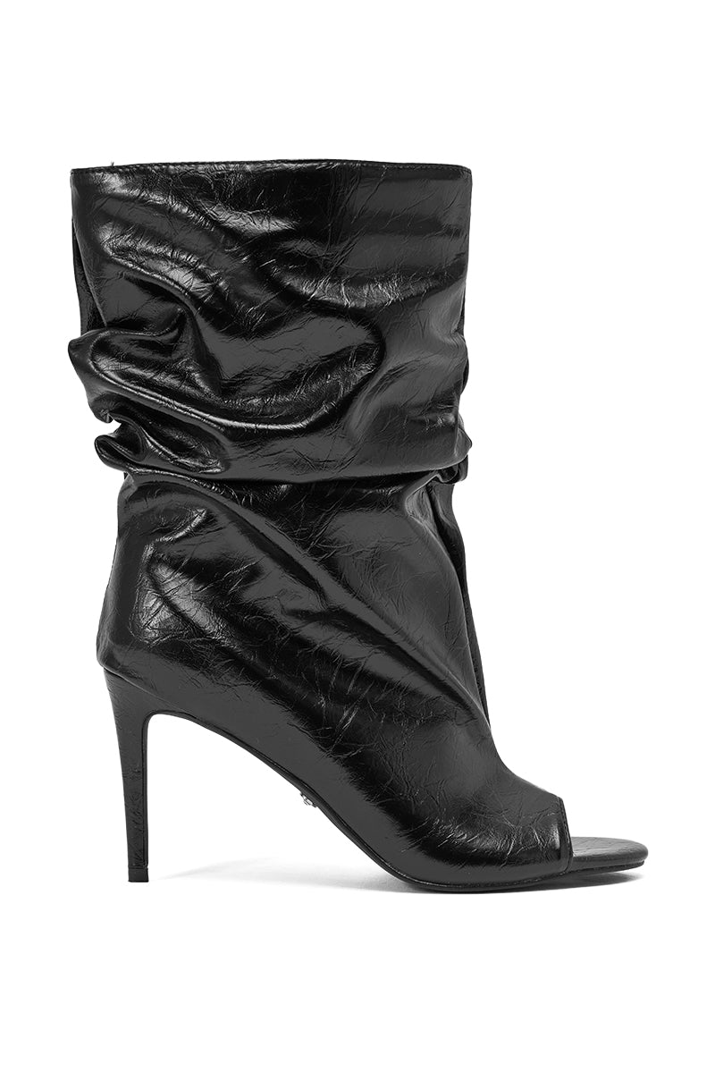 The AZALEA WANG IONE BLACK PU BOOTIE STILETTO is a slouchy, open-toe stiletto bootie in luxe black PU leather with a high heel, shown in profile against a white background. 4
