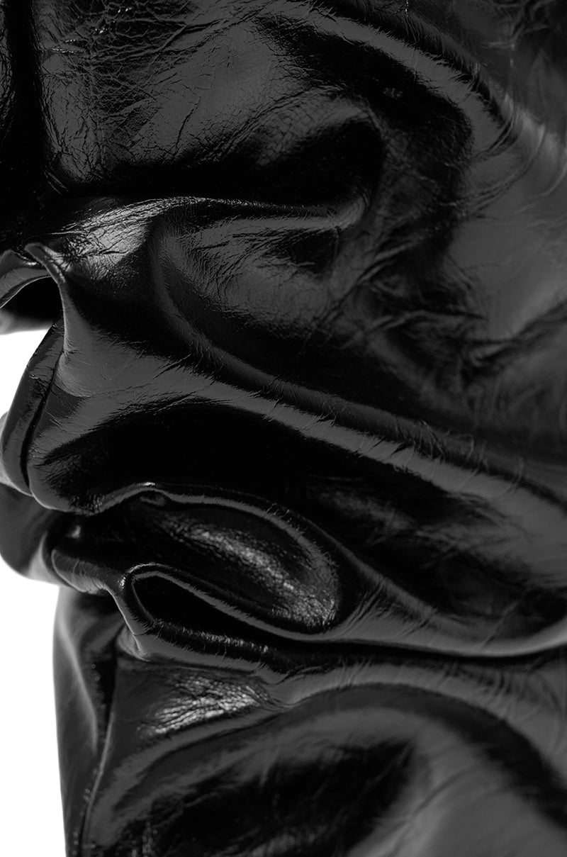 Close-up of shiny, crumpled black PU material with deep folds and creases, evoking the luxe texture and abstract highlights of the AZALEA WANG IONE BLACK PU BOOTIE STILETTO. 7
