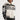 A woman with short hair wears the ON THE RUN MOTO BOMBER jacket, which is white and black with the word "Official" prominently displayed on the front. The jacket features the number 3 and star designs on the sleeves and is styled against a plain, white background.
