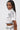 A woman with long straight black hair wears the BLANK SPACE CROPPED SHORT SLEEVE BUTTON DOWN and matching high-waisted pants with bold black line patterns, standing against a plain white background.