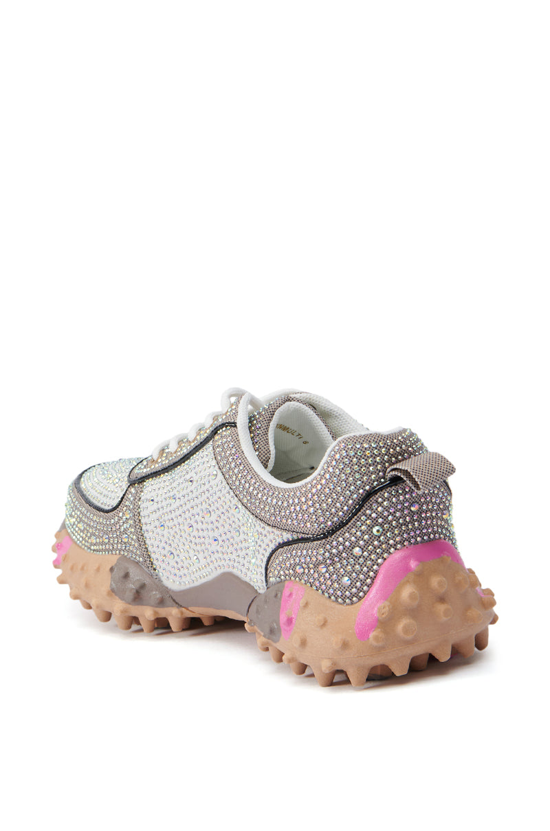 Introducing the AZALEA WANG ISABEAU BROWN MULTI SNEAKER: A striking close-up reveals its rhinestone embellishments and robust, chunky sole accented in bold pink and brown. The distinctive color-block design showcases a white mesh upper complemented by grey and beige overlays for a truly unique and captivating appearance.