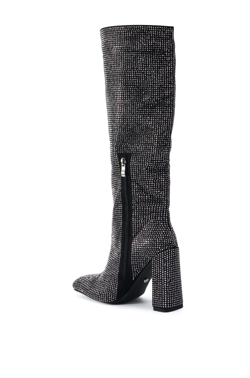The AZALEA WANG ISKANDER BLACK RHINESTONE BOOT is a black thigh-high boot with a chunky high heel, adorned with small, shiny silver studs in an intricate pattern. It features a side zipper for easy wear. 4