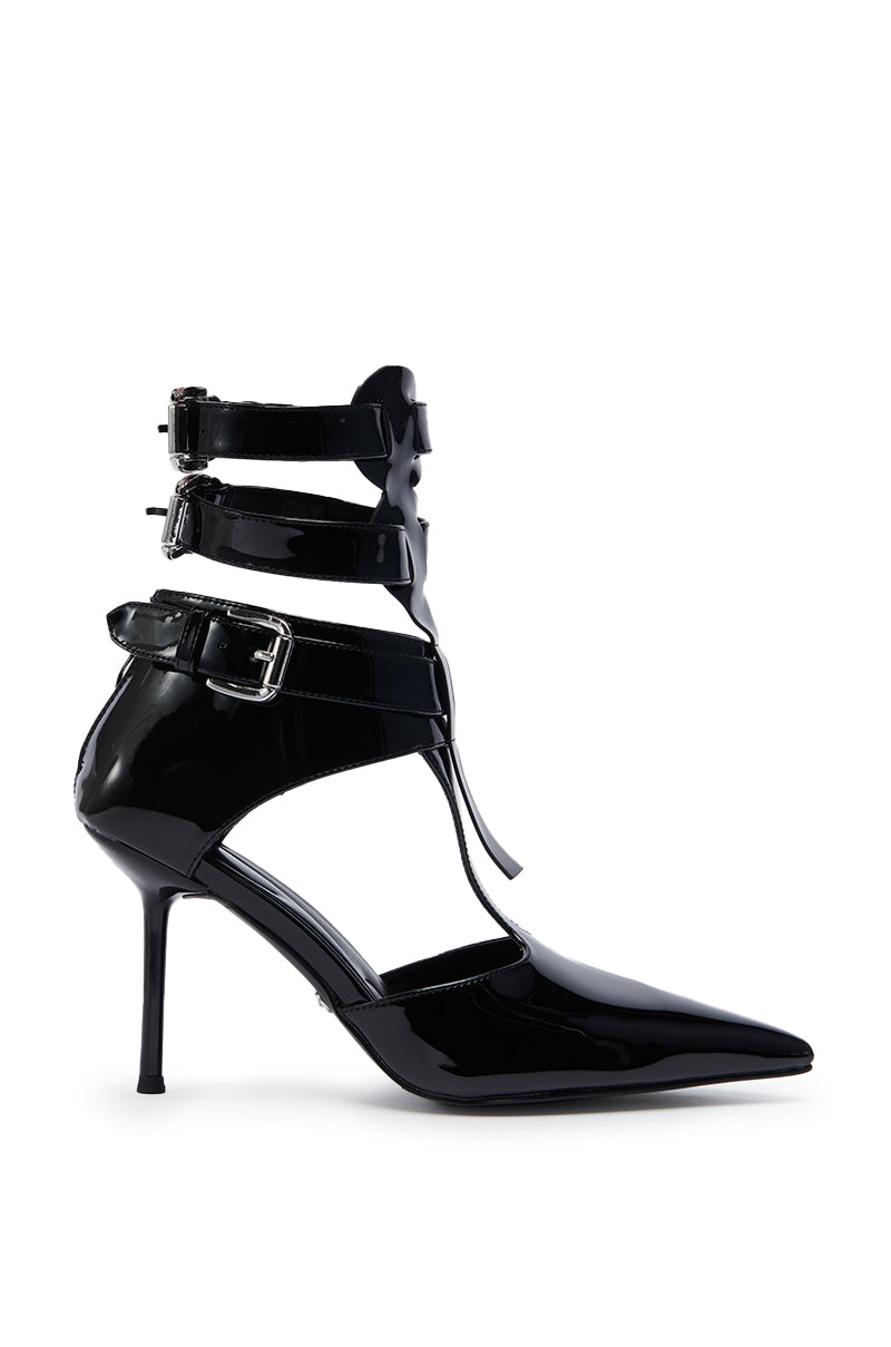 The AZALEA WANG ITHYKA Black Patent Stiletto Pump features a pointed toe, multiple ankle straps with silver buckles, and a glossy faux leather finish, shown on a white background.